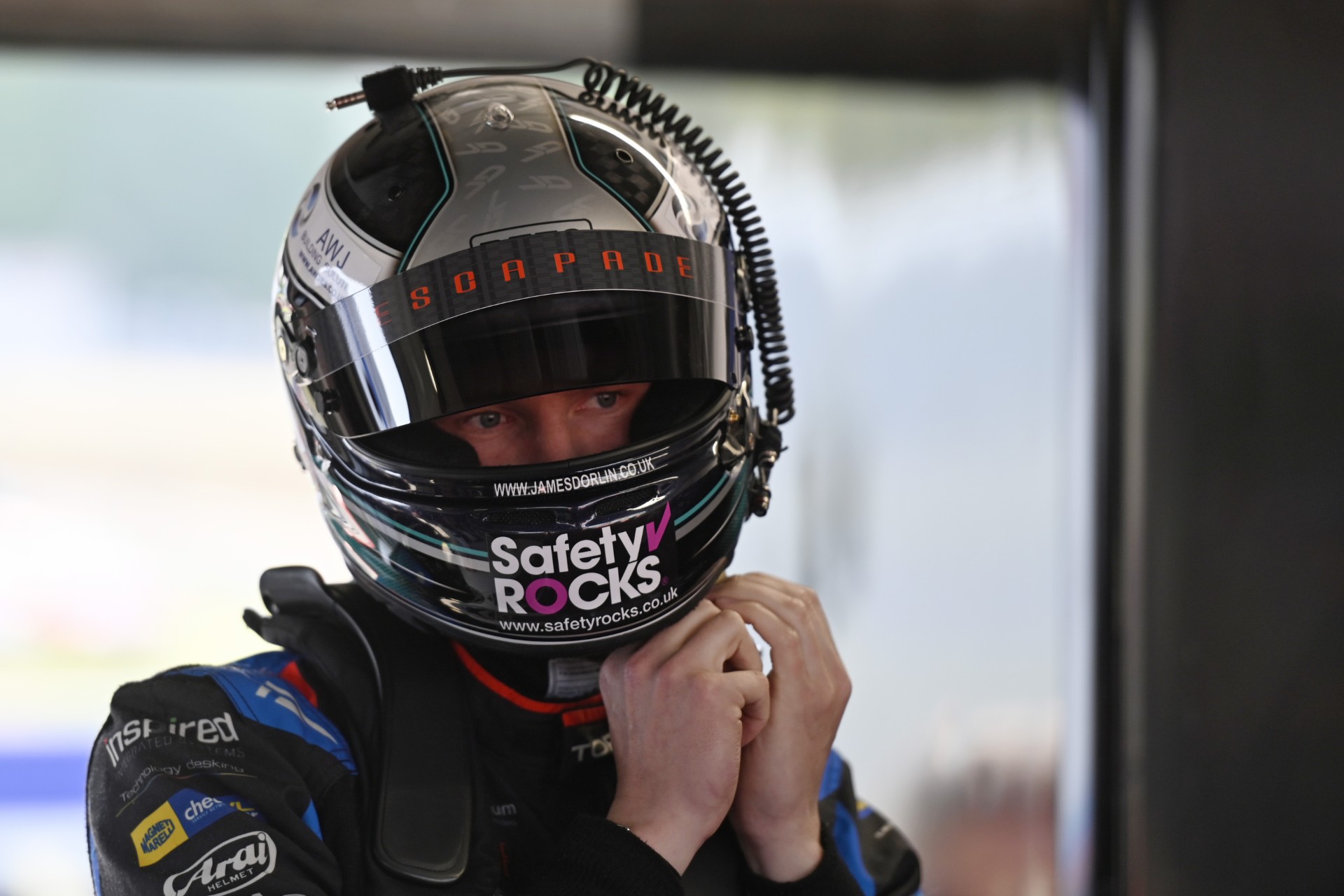 BTCC driver James Dorlin wearing his crash helmet displaying the Safety Rocks logo